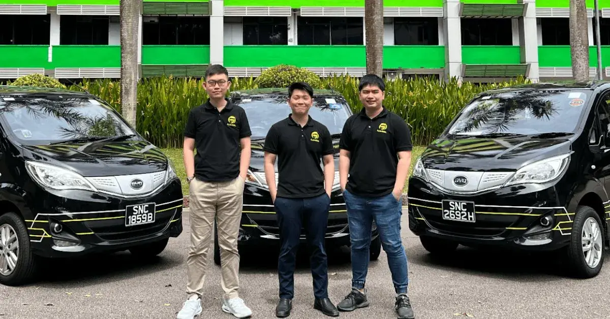 The RushOwl team in front of a row of branded vehicles